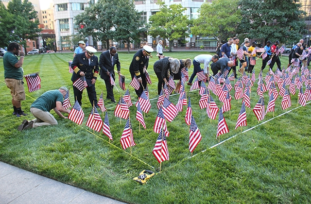 volunteers install the flags